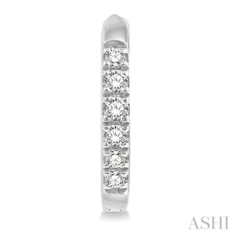 1/8 ctw Round Cut Diamond Huggie Earrings in 14K White Gold